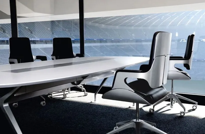 Interstuhl 262S chairs by Hadi Teherani around a boardroom table, their bent sheet-metal frames carrying the seat and back.