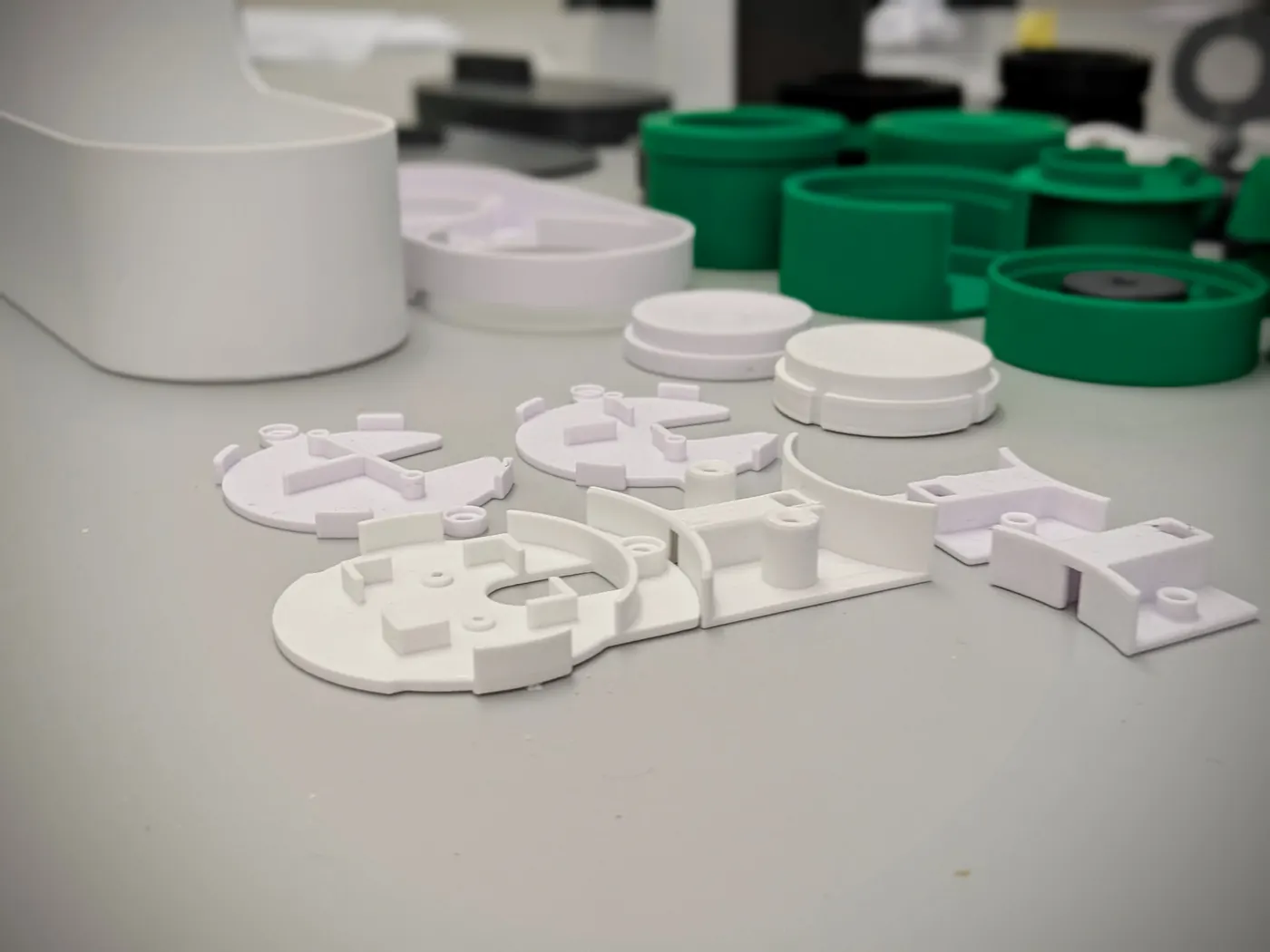 Printed test parts laid out on a workbench.