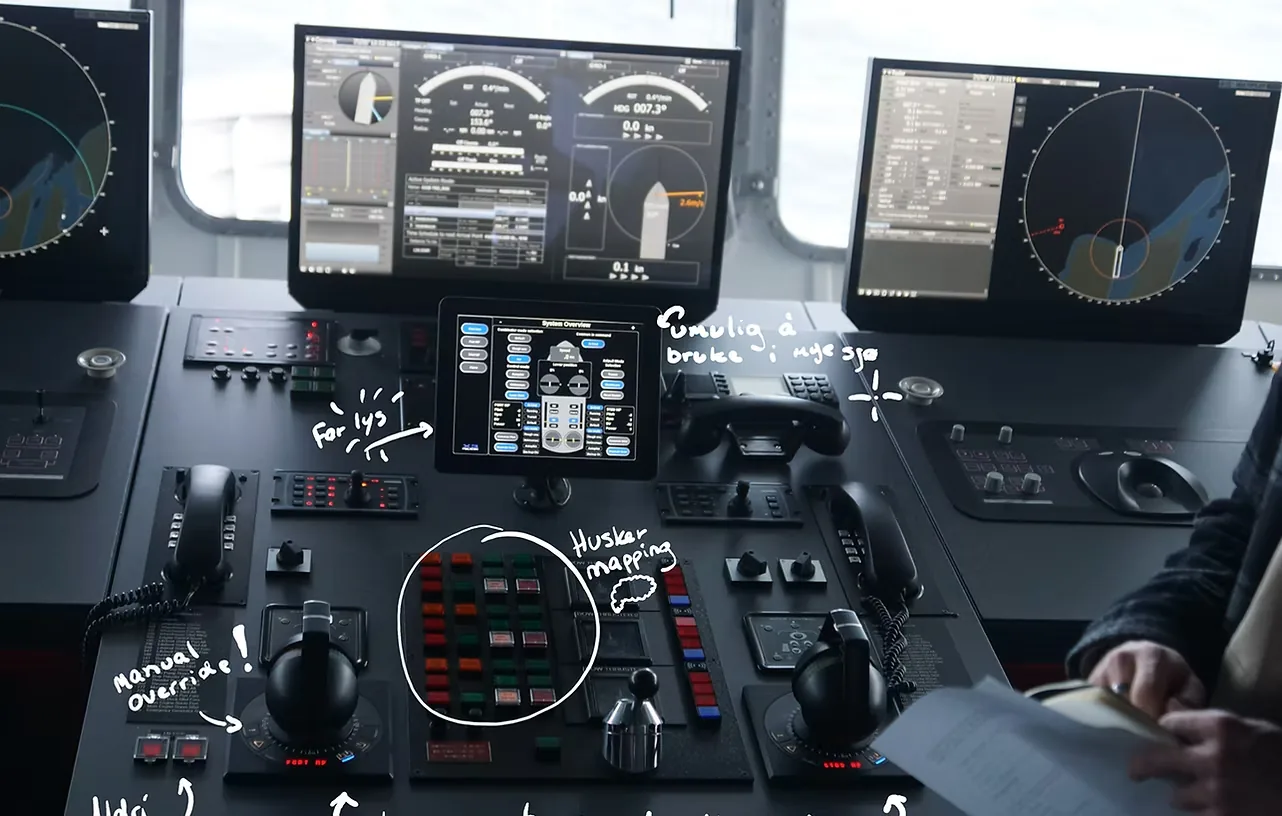 A vessel's existing bridge console, annotated by hand: unreachable controls, unreadable in heavy seas.