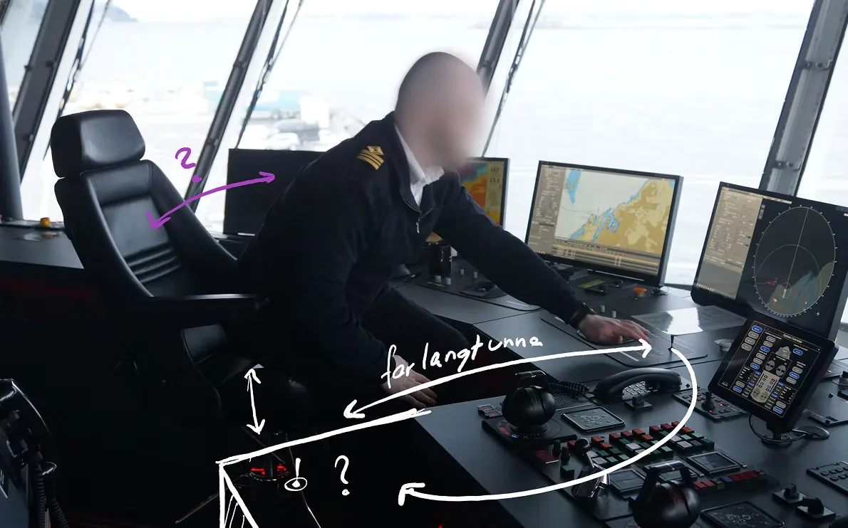 An officer reaching across the old console, annotated to show how far the controls sit from the seat.